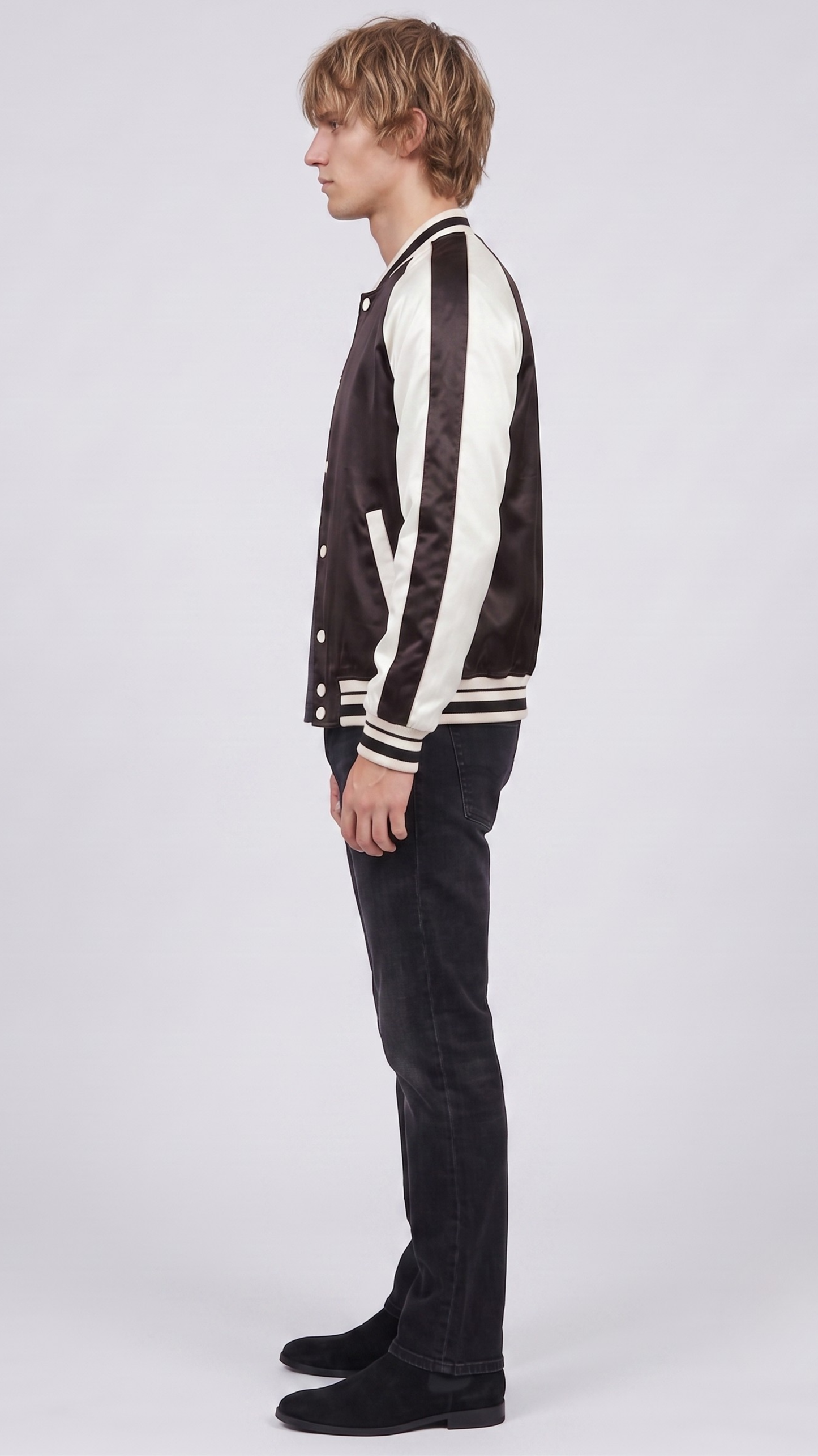 Detailed view of the athletic striped black and white rib-knit collar, waistband, and cuffs on a premium varsity bomber.