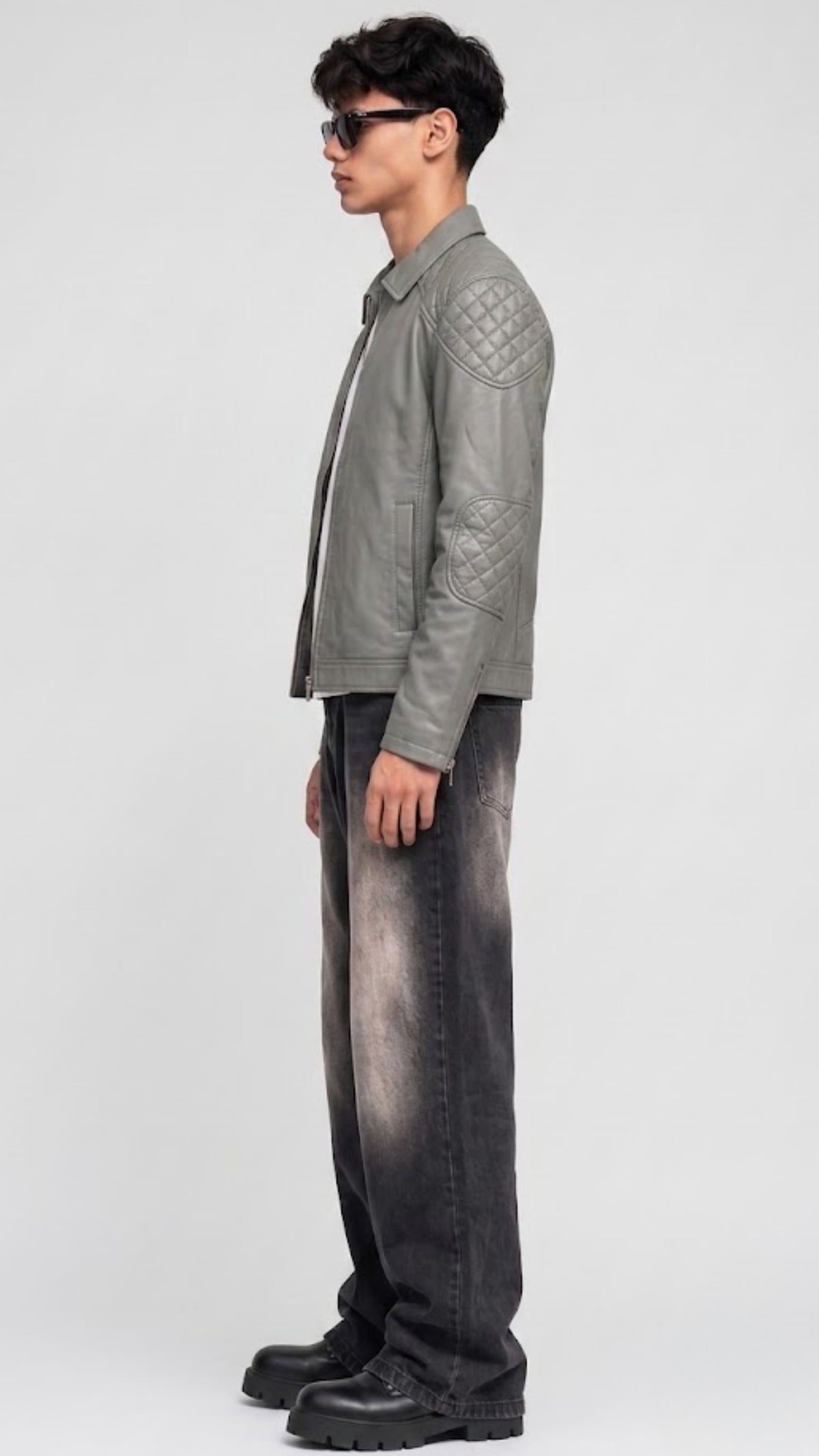 Side-angle profile view of a JACKERO regular fit ash grey leather jacket displaying a structured waistline and comfortable sleeve alignment.