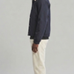 Urban lifestyle fashion photography of a casual layered men's look styled with a breathable dark navy cotton windbreaker jacket.