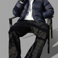 Man sitting on a chair wearing a navy puffer jacket