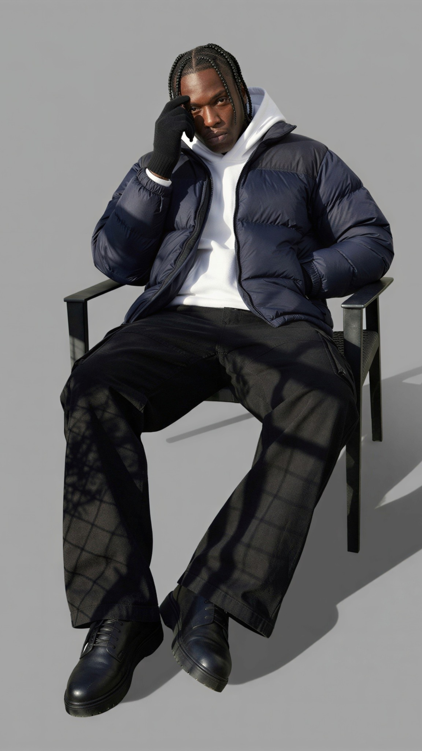 Man sitting on a chair wearing a navy puffer jacket