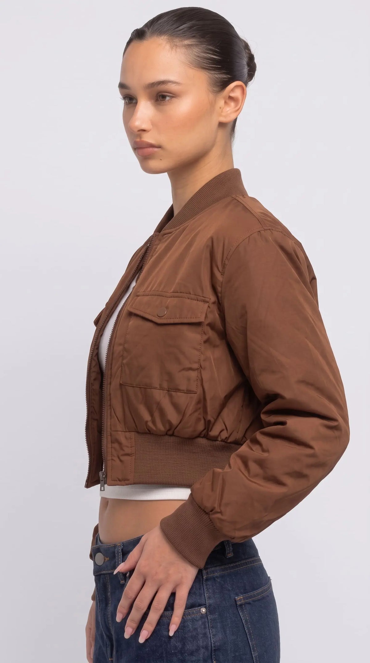 Women's contemporary high-fashion presentation featuring a sleek beige cotton silk jacket styled for an upscale casual everyday look.
