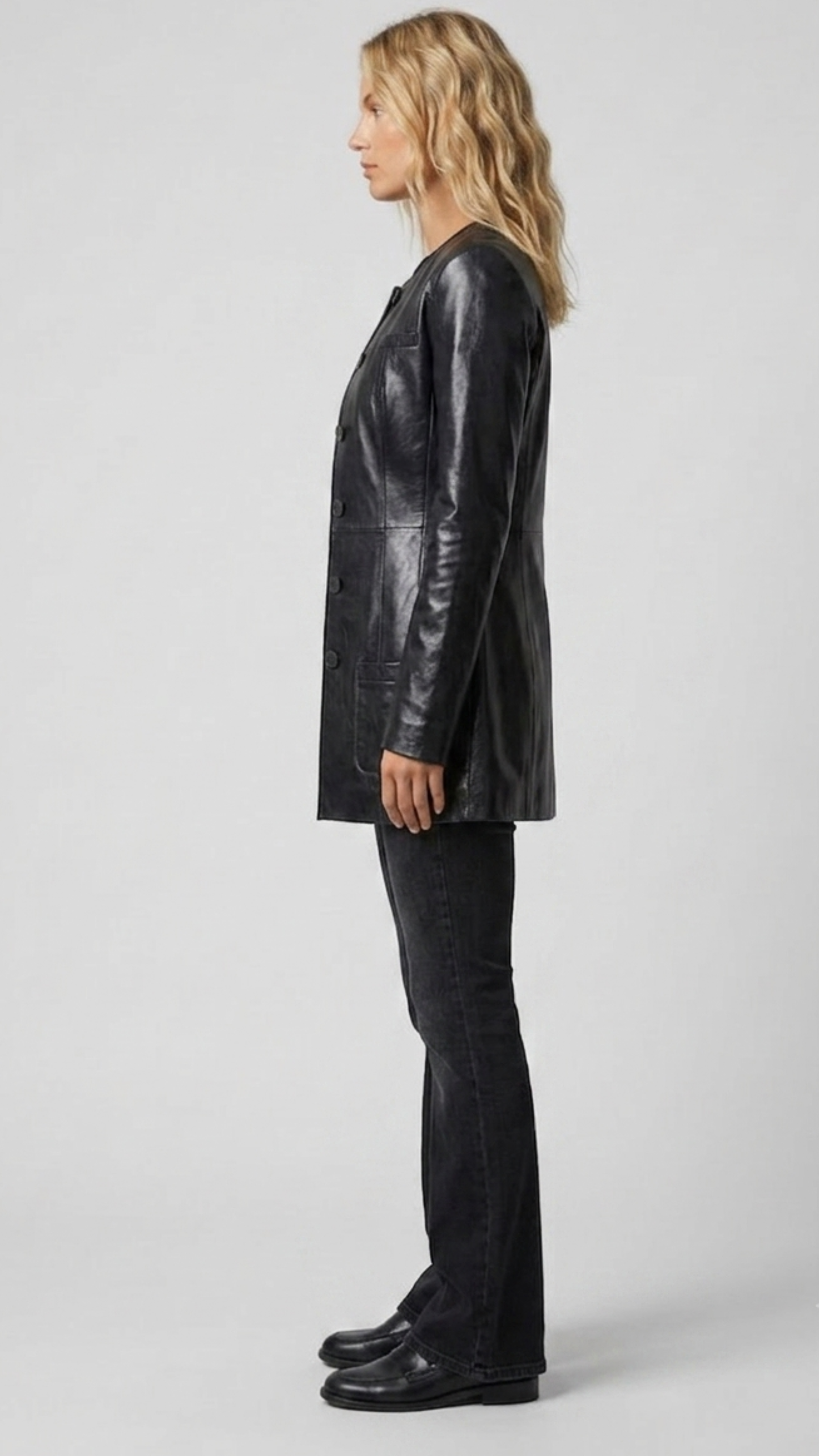 Detailed view of the adjustable leather waist belt and deep functional side pockets on a premium black leather trench coat.