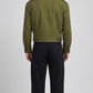 Mens casual style olive green cotton outerwear paired with vintage blue jeans