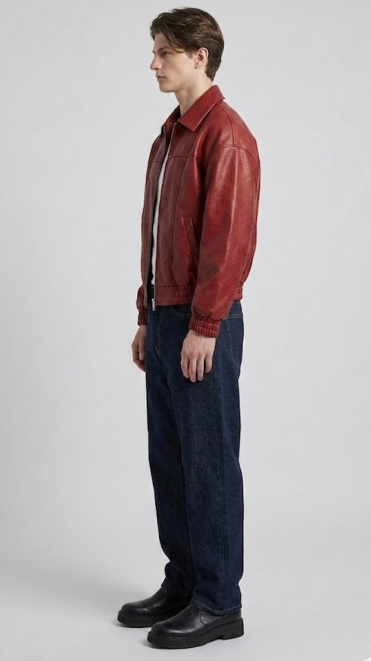 Premium streetwear fashion lookbook featuring a high-quality red leather bomber jacket with front zipper.