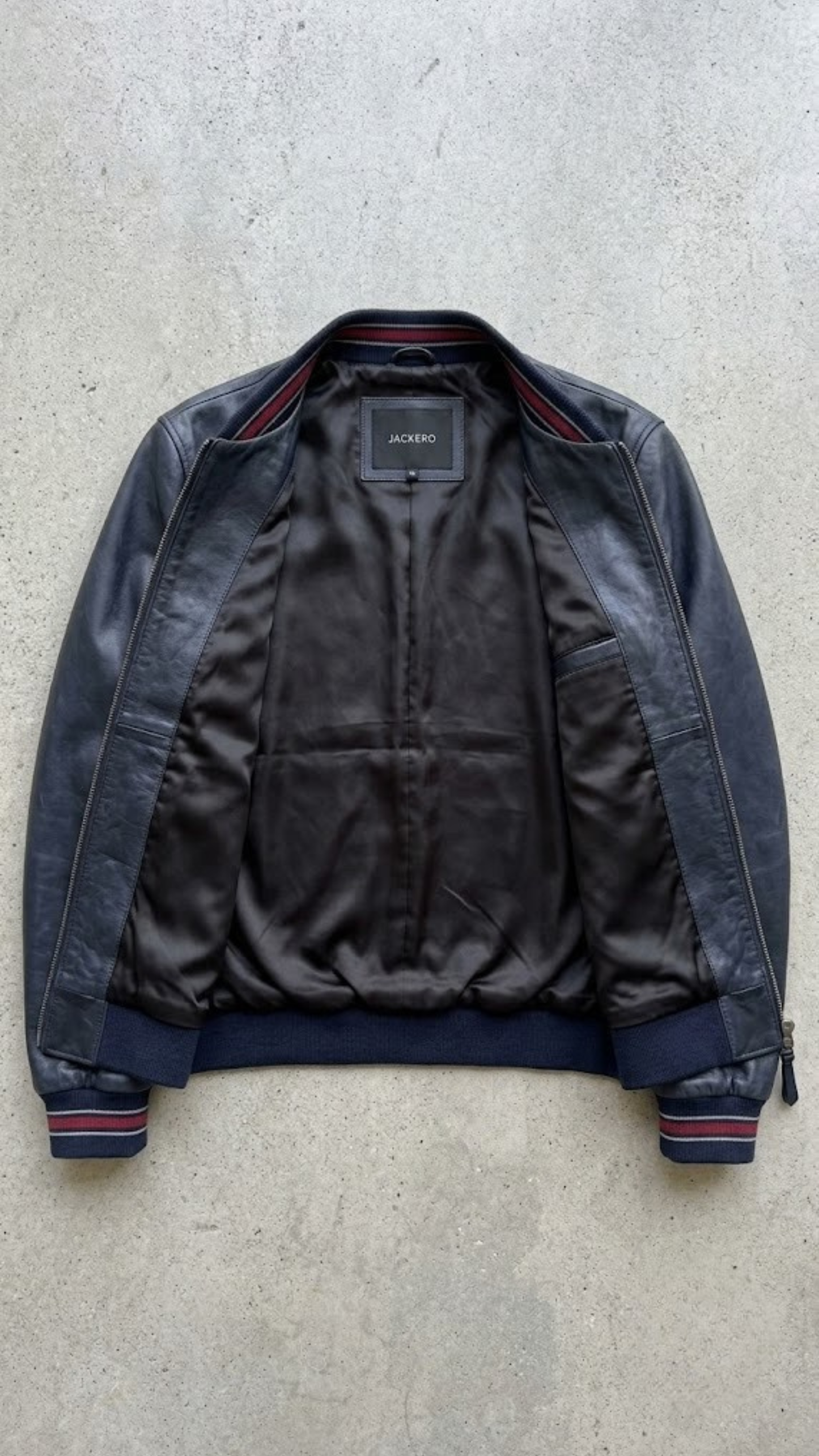 Jackero jacket flat lay presentation featuring the contemporary deep sapphire blue leather casual jacket neatly displayed on a neutral background.