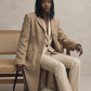 Studio portrait of a model styled in a sophisticated camel wool overcoat for a professional look.