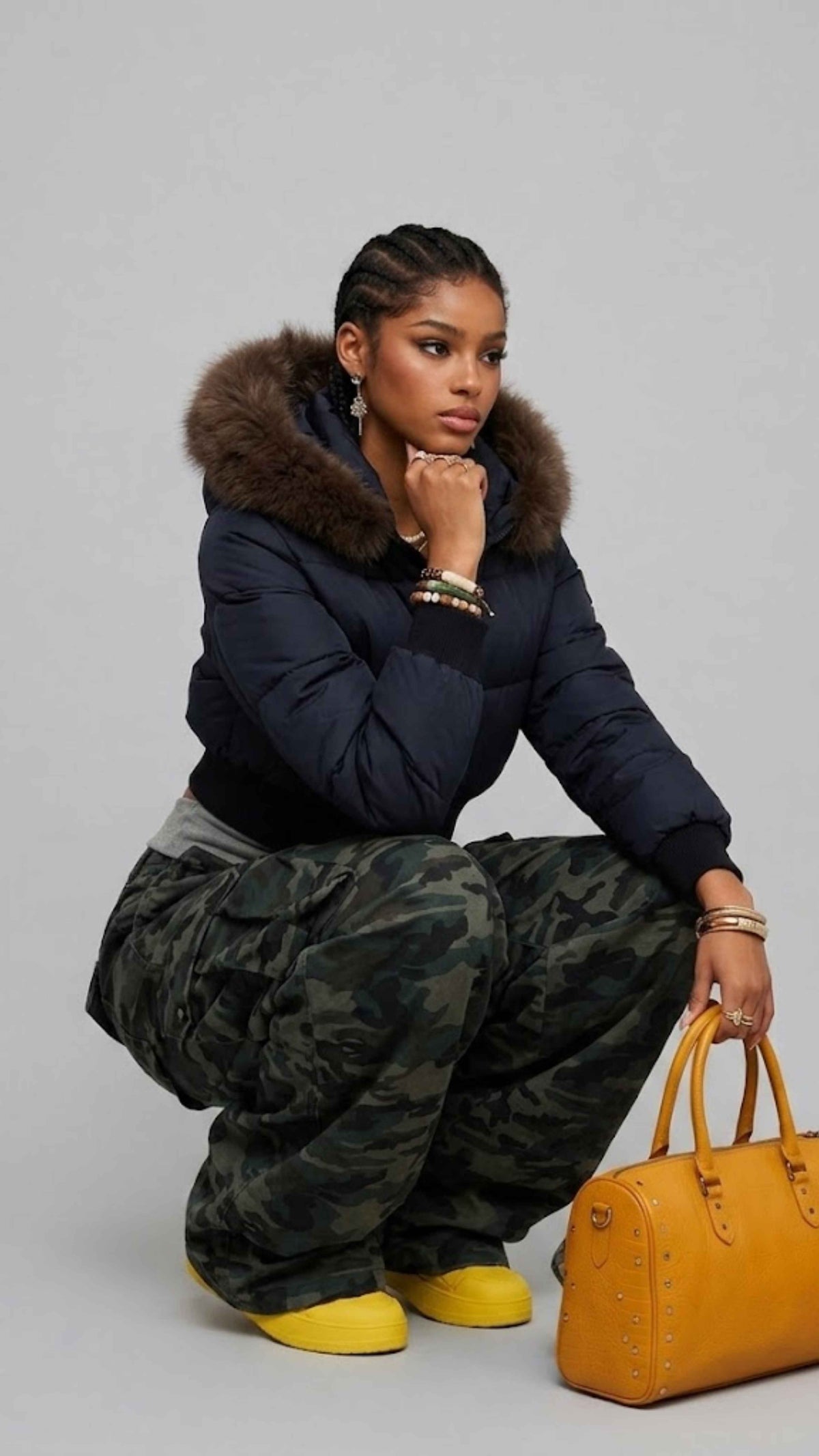 Detailed view of elasticated ribbed waistband, cuffs, and custom metal zipper on navy cropped outerwear