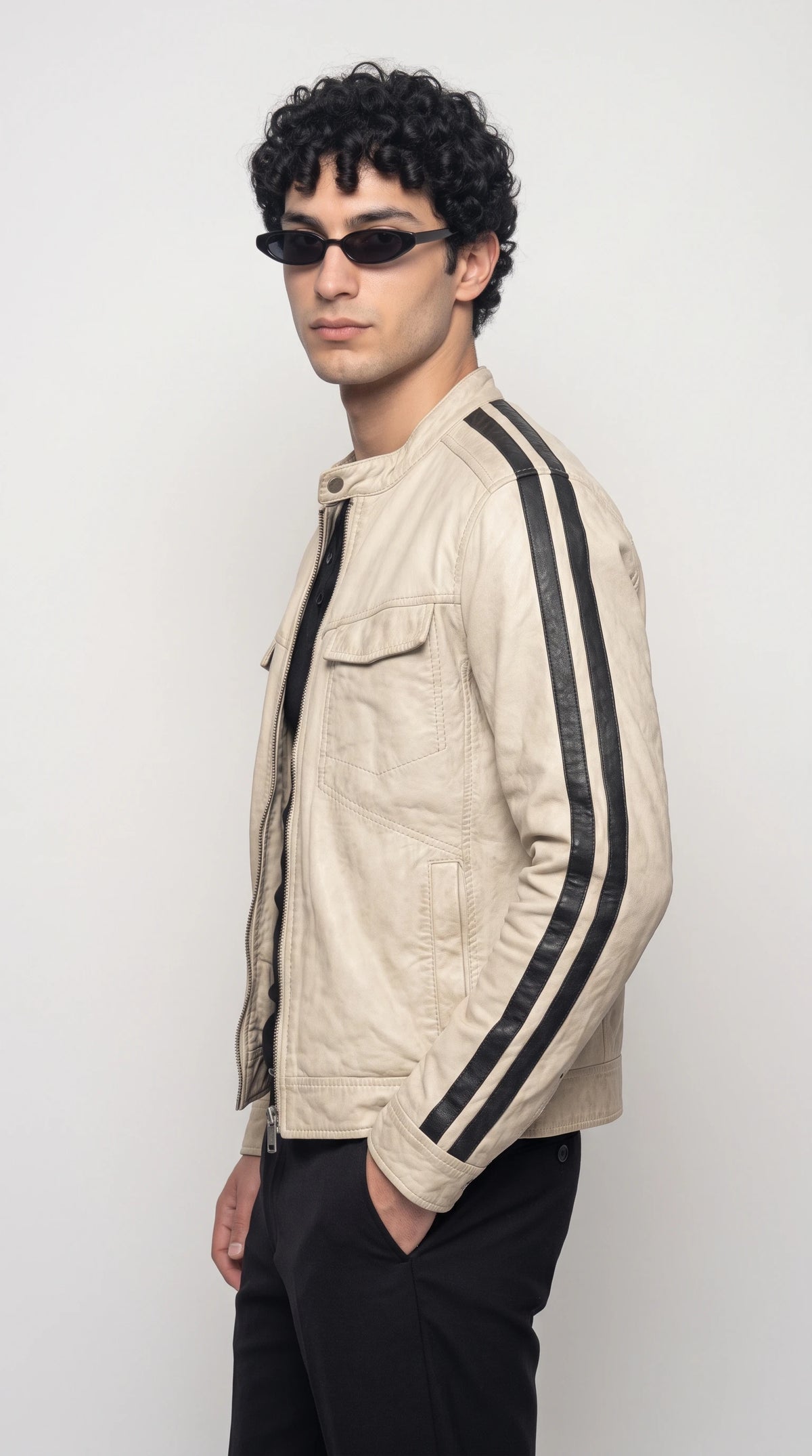 Off-white leather racer jacket with long black contrast stripes extending from the shoulders down the sleeves and sides, creating an athletic colour-block effect that pairs effortlessly with dark denim and minimalist urban outfits.