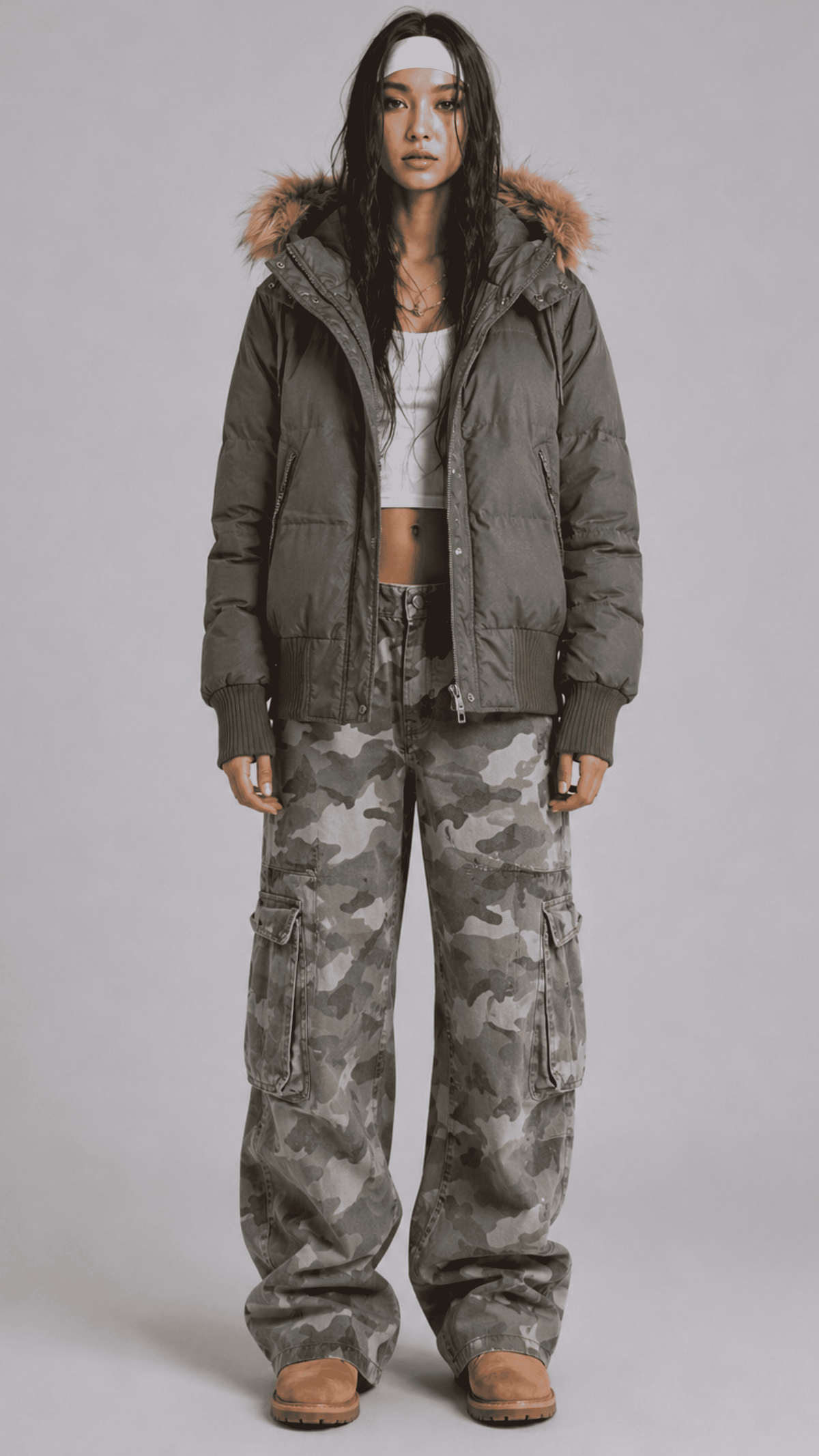 Front view of model wearing an oversized olive green puffer jacket featuring a plush fur trim hood and full zip closure