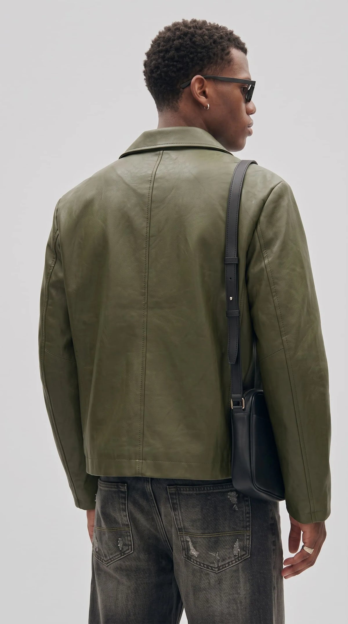 Minimalist collared olive leather jacket for men, clean modern menswear with a boxy cropped fit