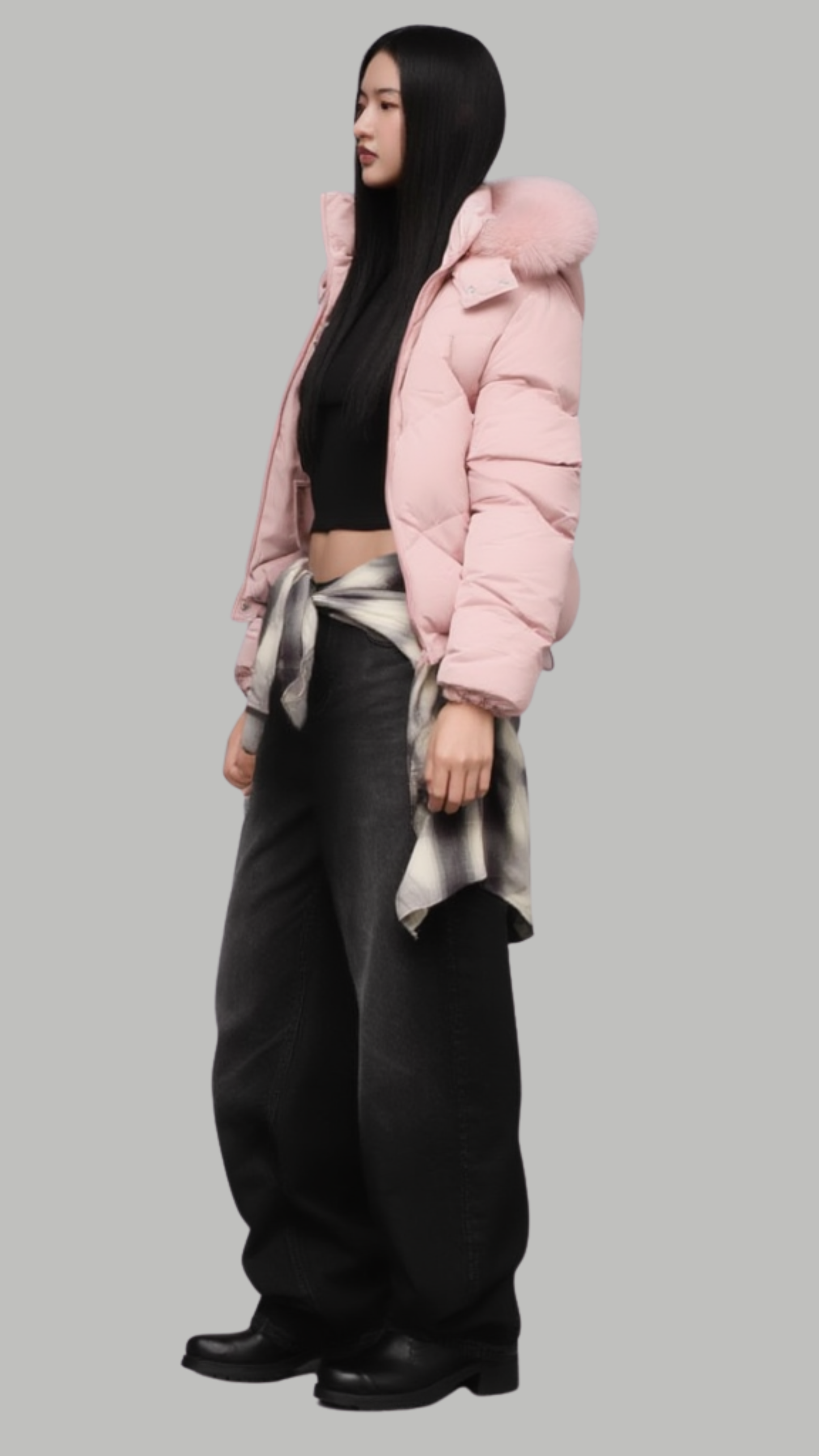 Minimalist lookbook style photography of a lightweight yet highly insulated pink puffer coat with a fur hood on a clean neutral backdrop.