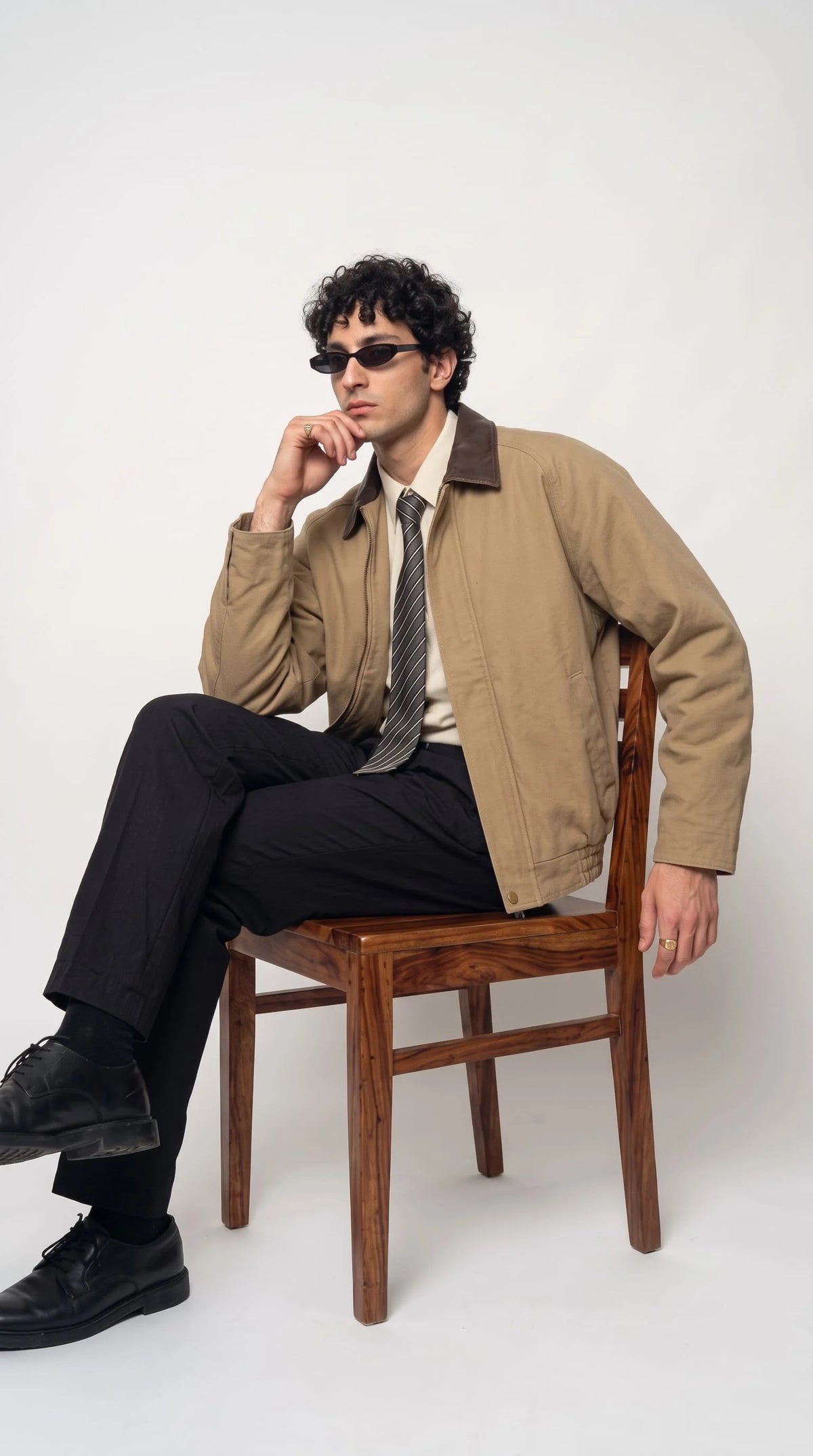 Vintage-style workwear jacket in beige cotton canvas with leather collar, modeled in a streetwear look