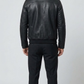 Straight-on back view of a structured black leather aviator jacket showcasing its ribbed waistband and clean bomber fit.