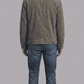 Tailored fit dark grey utility suede outerwear layered over a casual sweater for a modern rugged aesthetic.