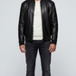 a model showcasing the Jackero premium classic black leather bomber jacket styled with high-end minimalist menswear.