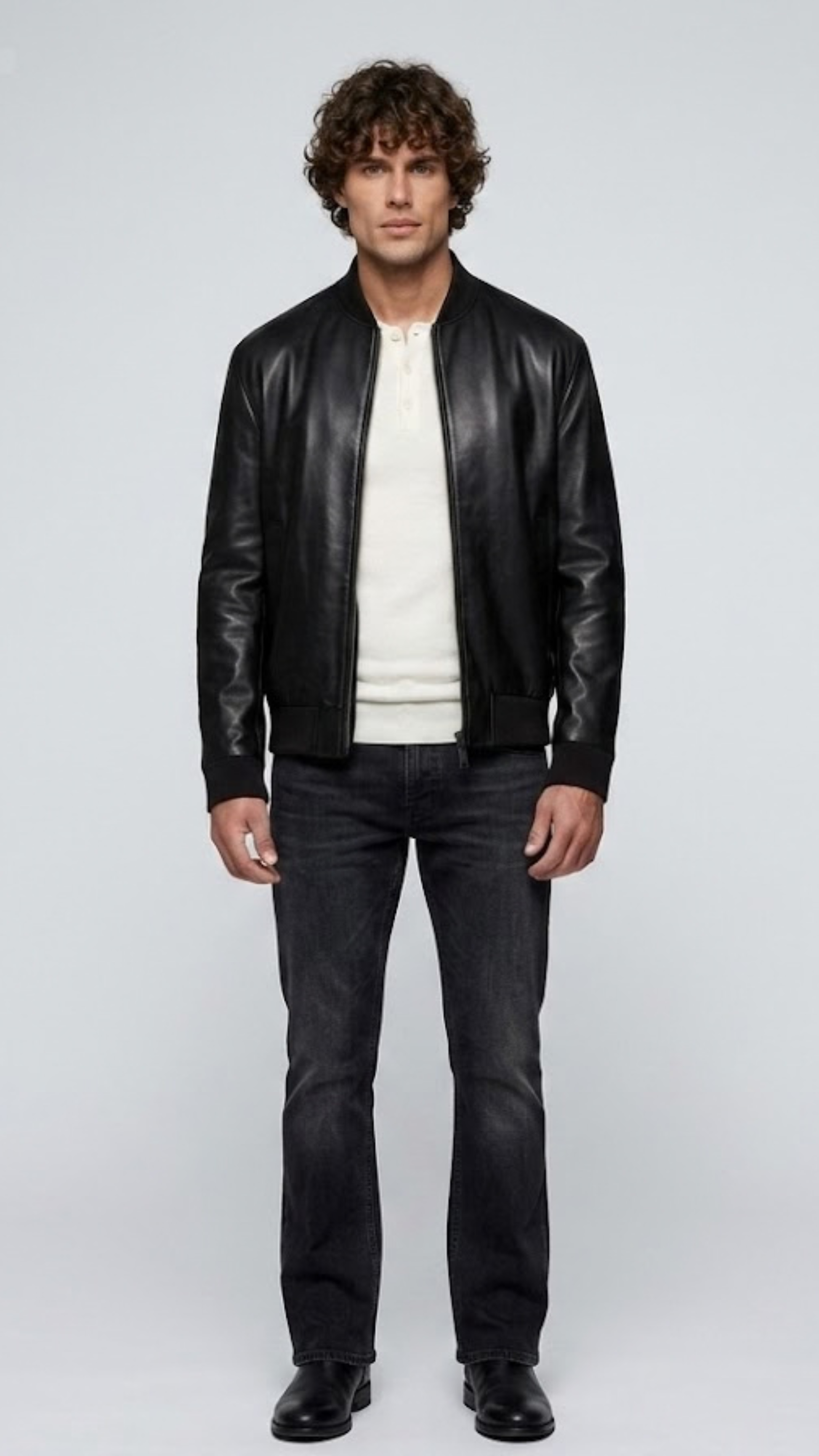 a model showcasing the Jackero premium classic black leather bomber jacket styled with high-end minimalist menswear.