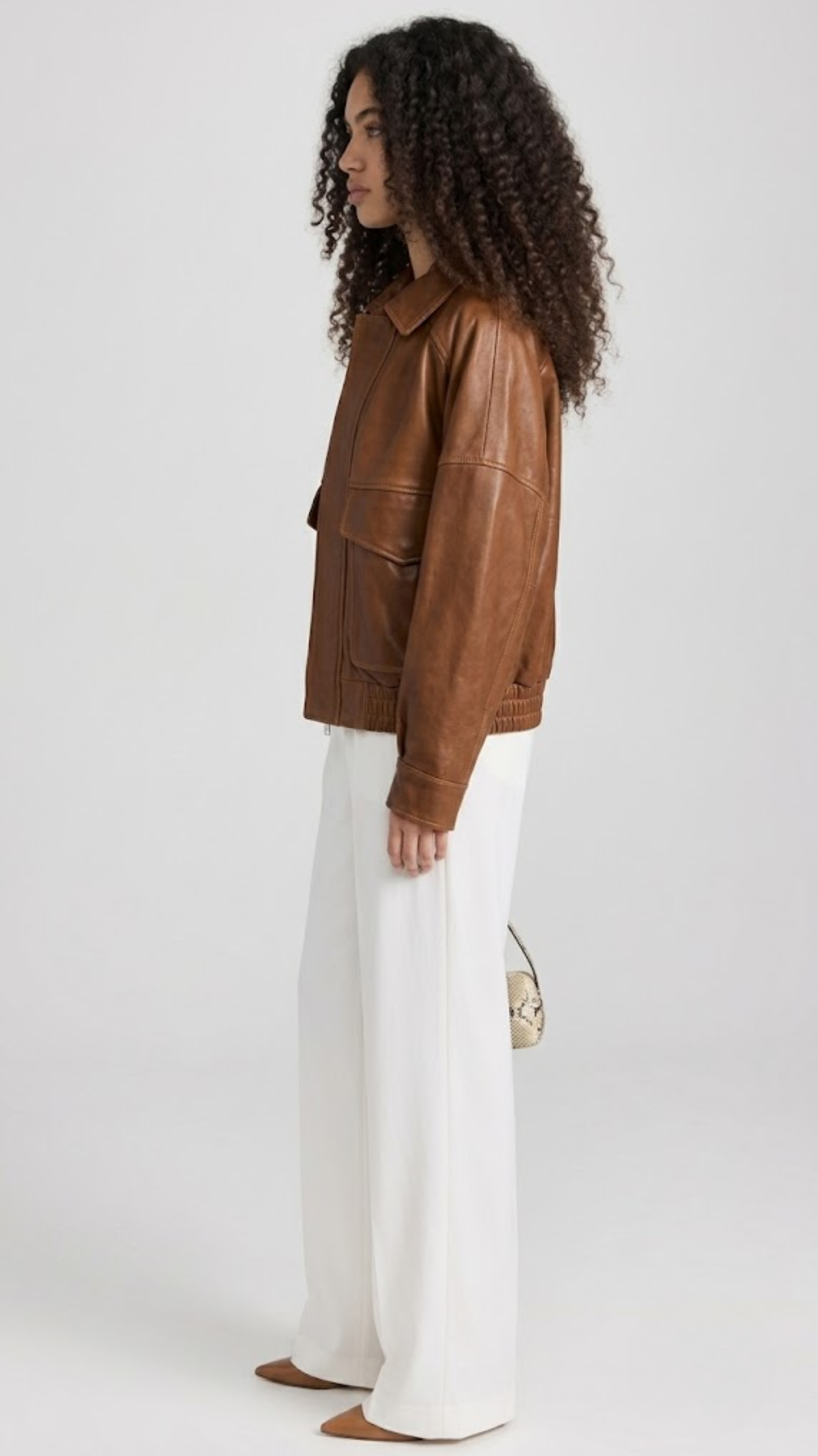 JACKERO Cognac brown real leather bomber jacket with a classical shirt collar, elasticated waist hem, and snap cuffs.