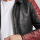 Close-up of the detailed red quilting pattern on a premium black leather hooded motorcycle jacket.
