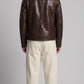 Back view of a custom dark brown leather jacket showcasing the continuous embossed crocodile texture and structured fit.
