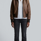 Front view clean lookbook photography of a model wearing Jackero dark brown leather bomber jacket over a casual winter shirt style.