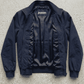 Flat lay presentation of Jackero dark navy blue cotton jacket showing unlined lightweight interior and inner brand tag