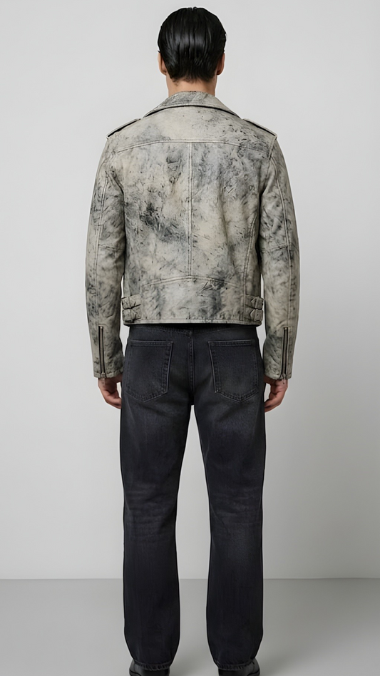 Model wearing a two-tone off-white and black distressed leather coat with heavy metal zippers.