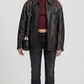 A professional lookbook front shot of the Jackero premium distressed black leather trucker jacket with button-up closure details.