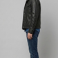 Contemporary lifestyle streetwear look presenting a sleek black leather button-up jacket with functional flap pockets.