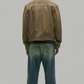 Straight-on back view of Jackero custom-fit tan leather outerwear highlighting clean stitching and premium horizontal panel alignment.