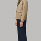 well-tailored beige cotton jacket showcasing symmetrical pockets and a clean fit.