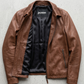 Jackero brand brown leather jacket on a solid grey backdrop, emphasizing timeless craftsmanship.