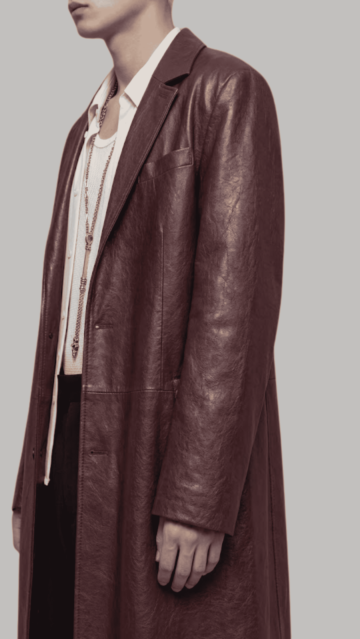 Close-up shot of broad notch lapel collar and rich dark red vine grain leather texture