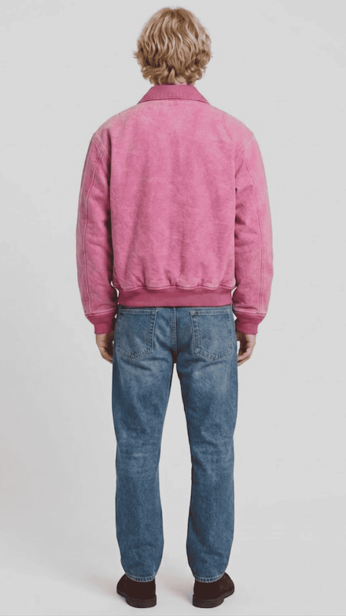 Elegant rose pink soft suede bomber jacket layered over a neutral tee, perfect for an effortlessly clean smart-casual outfit.