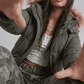 Detailed close-up shot of the plush faux fur trim and insulated hood on an olive green oversized winter jacket