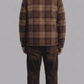 Tailored fit checked flannel winter outerwear styled effortlessly over a hoodie for a modern urban streetwear look.