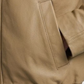 Close-up of a beige jacket with a pocket