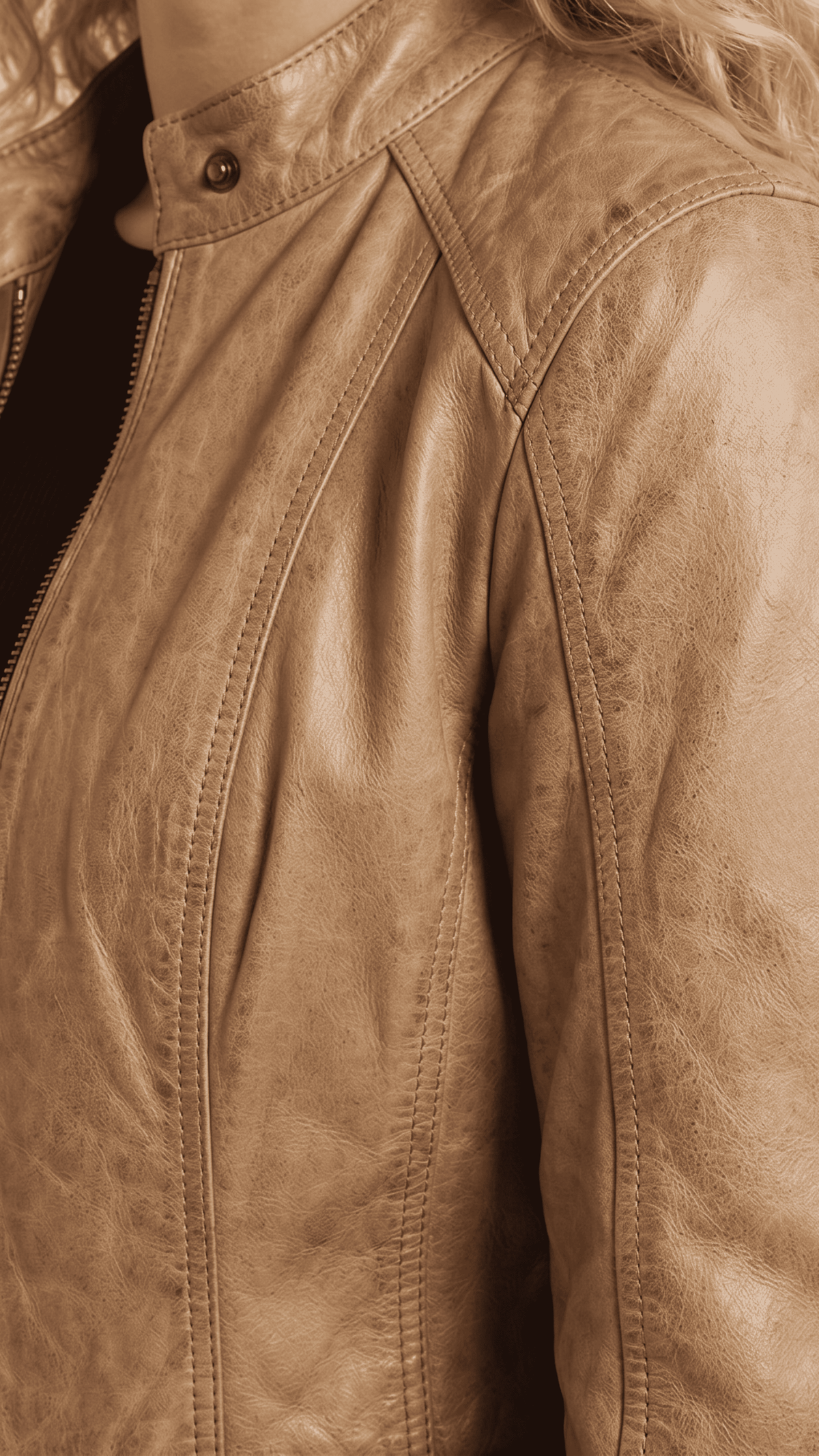Detailed close-up showing the smooth texture and light tan dye of premium genuine leather, complemented by sleek metallic zippers.