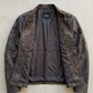 Flat lay view of Jackero premium distressed charcoal leather outerwear on light background