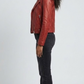the classic snap-button lapels, collar construction, and zippered pockets of a red leather biker jacket.