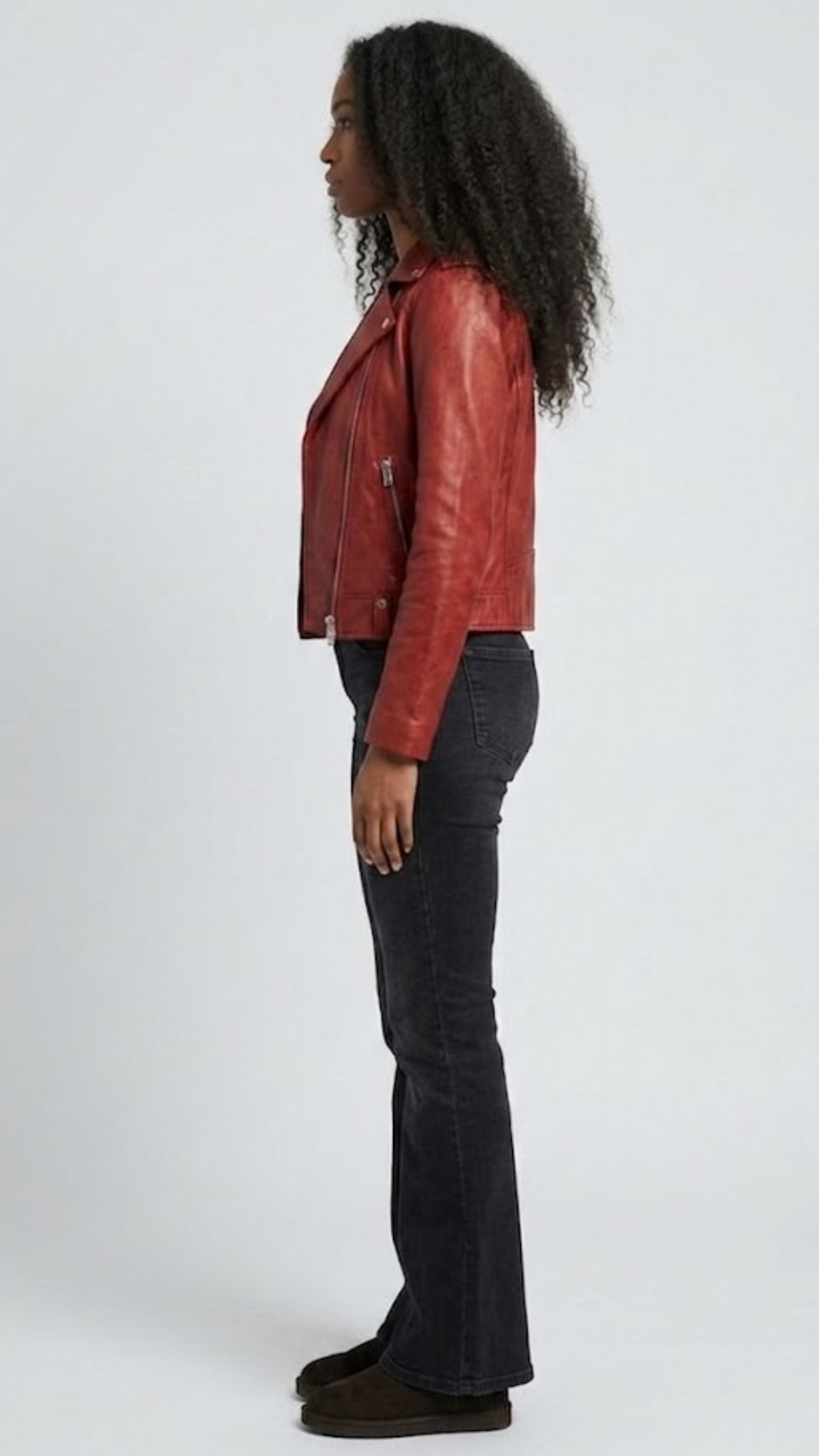 the classic snap-button lapels, collar construction, and zippered pockets of a red leather biker jacket.