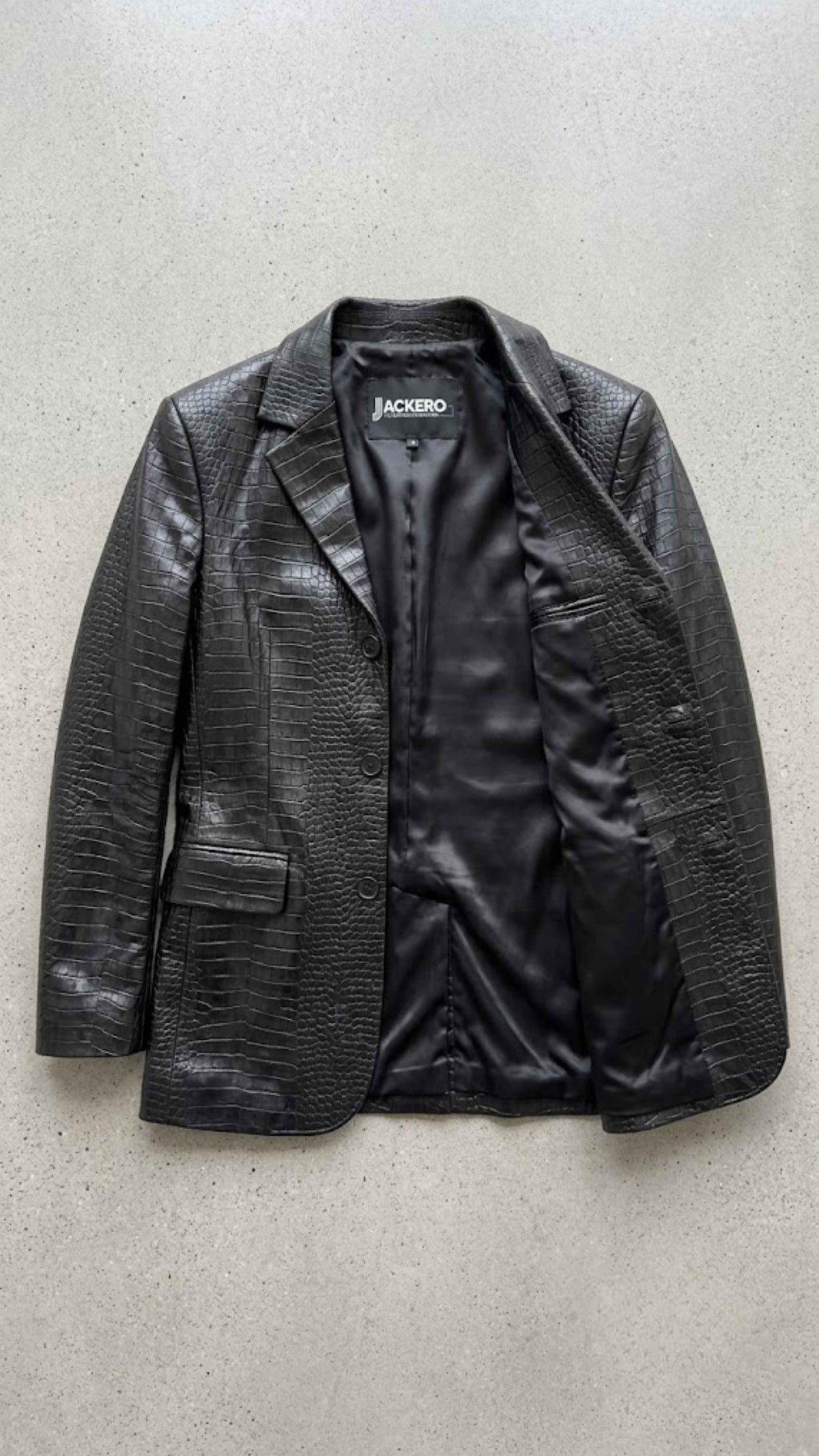 Flat lay view of Jackero black crocodile women blazer showing smooth inner lining and tailored collar structure