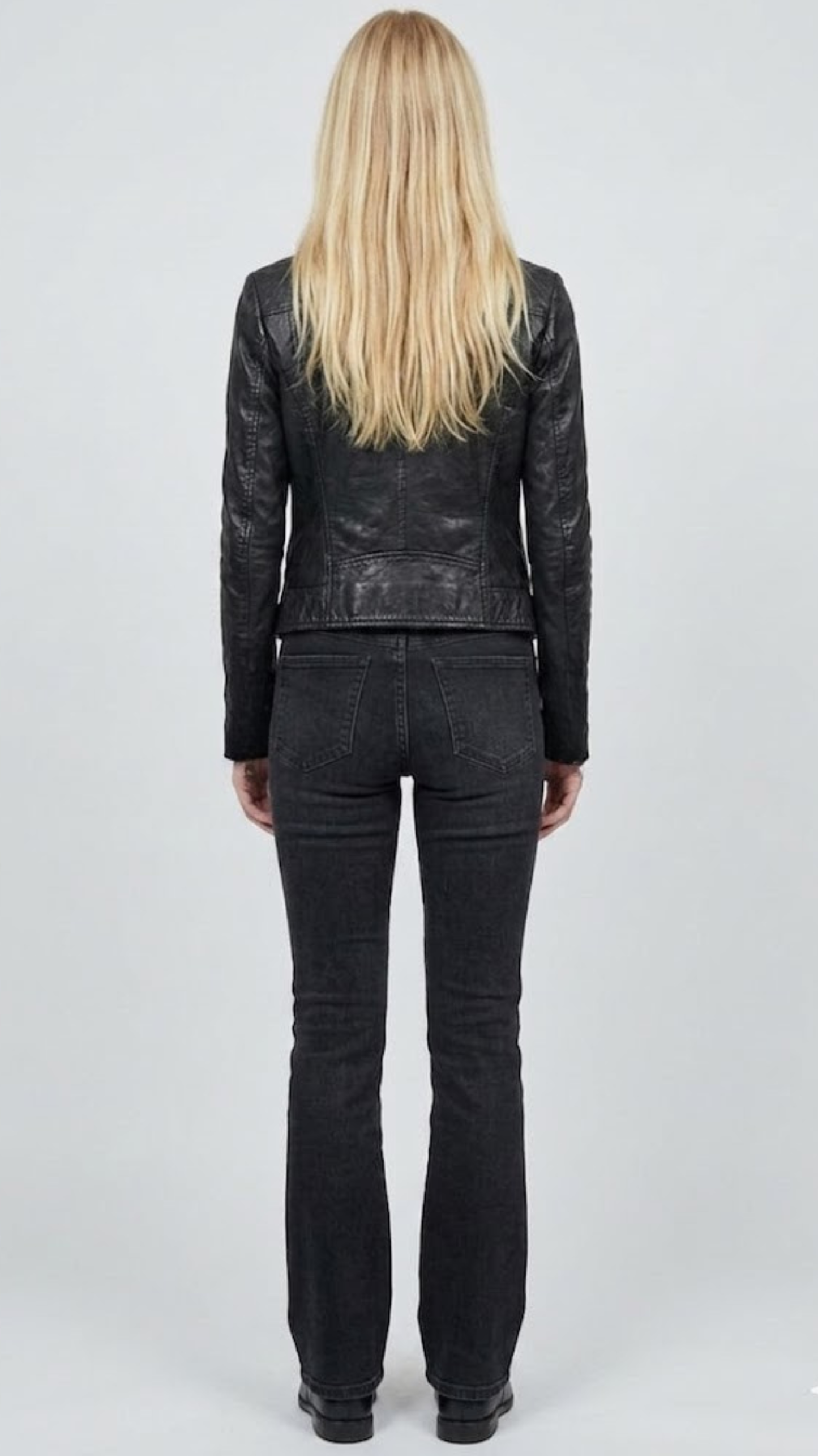 Tailored fit women's black leather sportcoat offering a clean silhouette with functional side flap pockets.