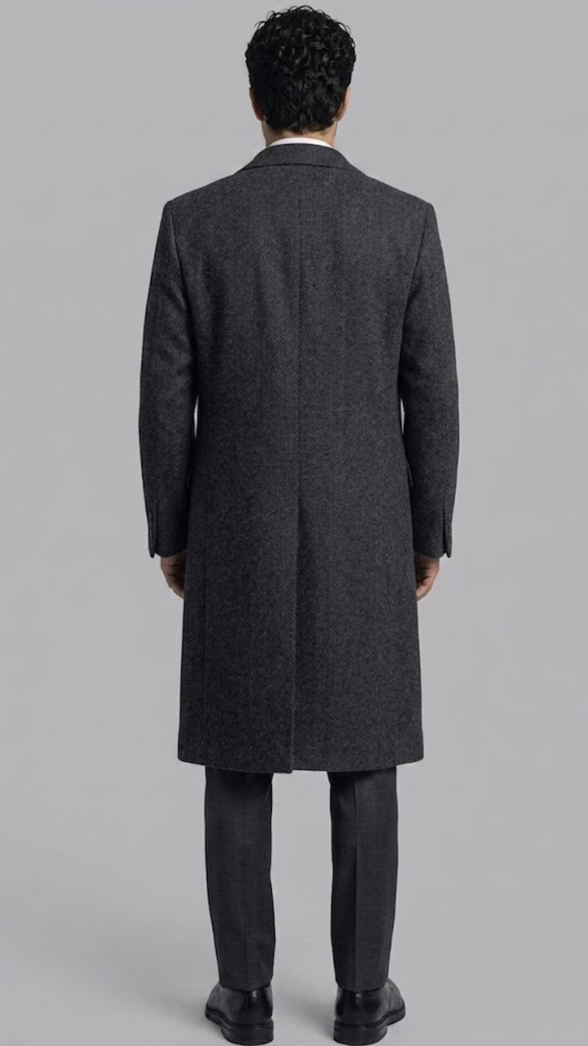 Regular fit men's dark grey wool long coat with functional side pockets, offering a clean modern profile.