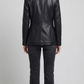 back-angle profile of a regular fit women's black leather dinner jacket displaying smooth drape and premium leather material quality.
