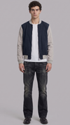 a premium dark navy blue and grey cotton jacket featuring a clean zip-up front and structured collar.