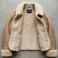 beige leather aviator coat showing the clean tailored silhouette and prominent cream shearling