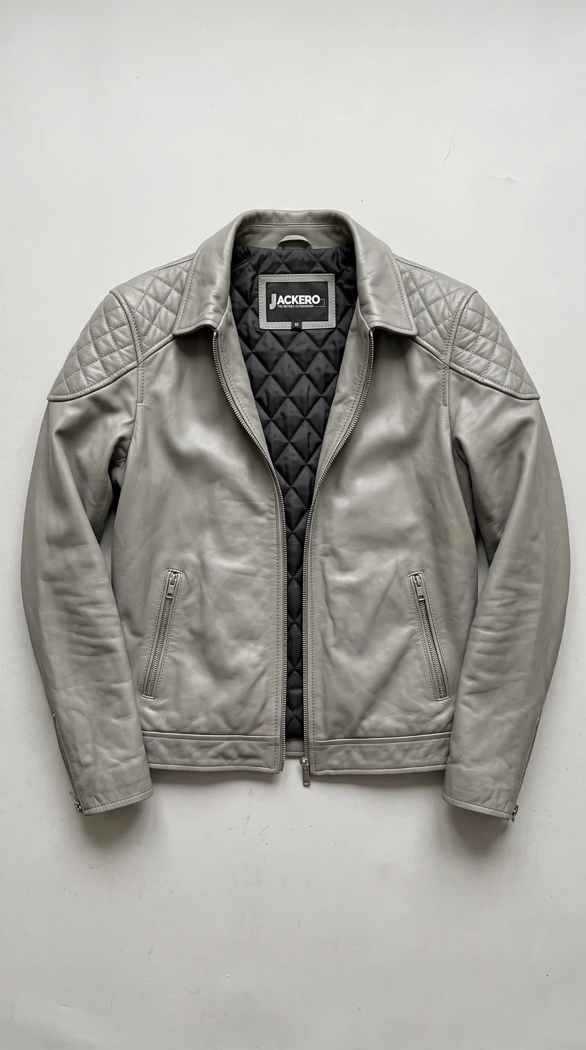 Open men’s grey leather jacket showing the quilted inner lining and two interior pockets, an easy layering winter jacket for cold weather outfits