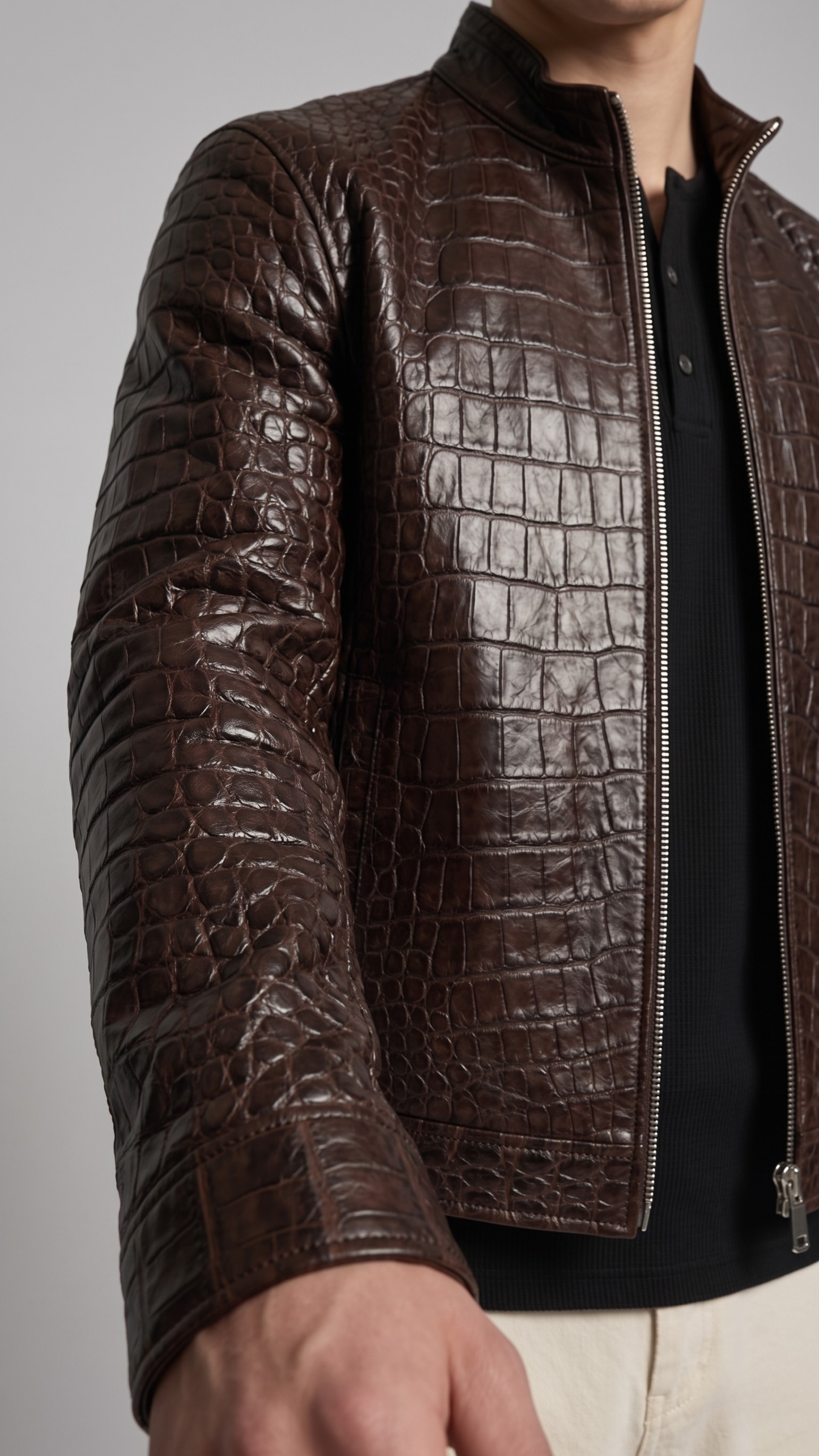 jackero Brown crocodile skin jacket worn by a person on a gray background