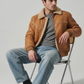 Classic vintage-style tan leather coat with soft cream sherpa lining, perfect for cold weather fashion.